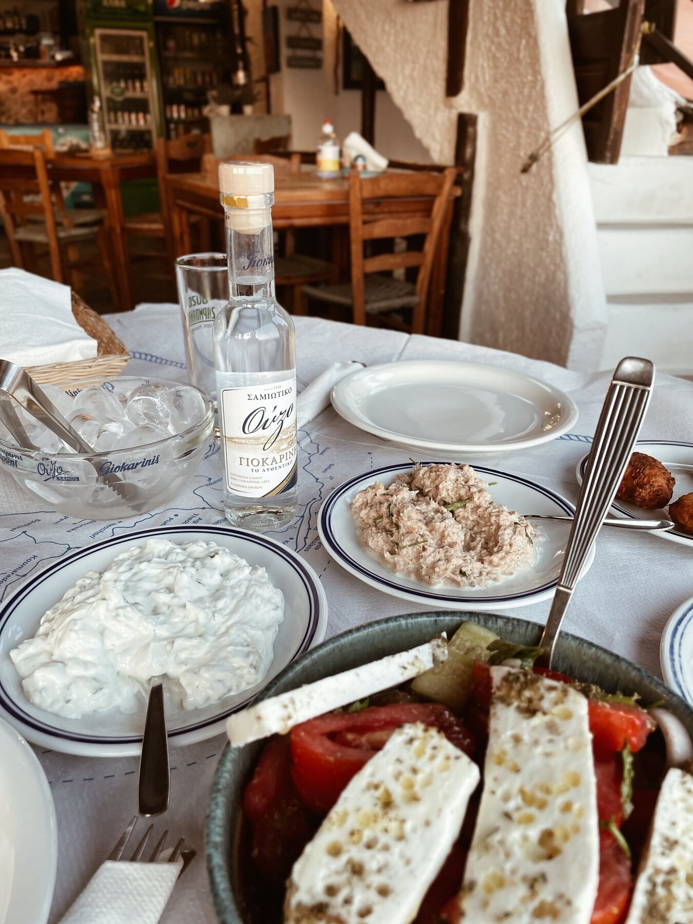 Traditional Greek table with salad, dips and ouzo